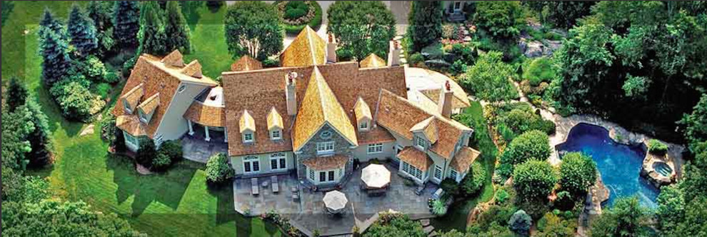 Aerial view of an intricate cedar roof and landscaped residential property