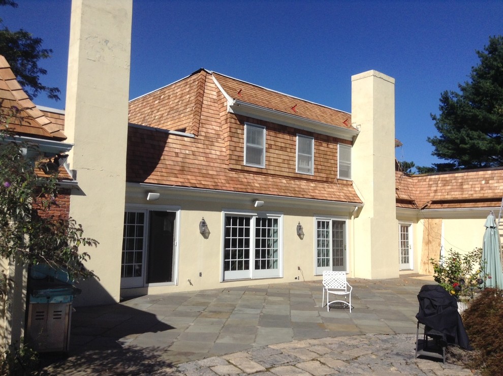 Rear exterior view of a residence with a detailed cedar roof